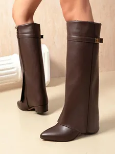Detailed close-up view of dark brown leather pant-leg boots with pointed toe and buckle strap