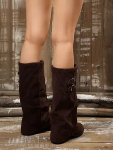Detailed view of retro dark brown suede mid-calf boots featuring stylish side buckles