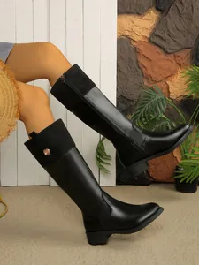 Black patchwork knee-high knight boots with round toe and decorative gold button details