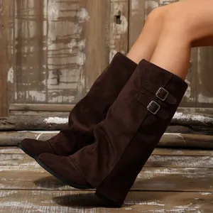 Close-up of retro suede pointed toe slouch boots with stylish double buckle straps