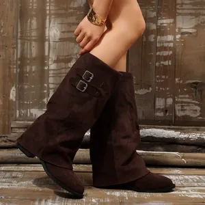Detailed view of brown suede long boots with stylish side buckle design