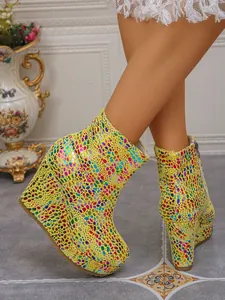 Detail view of colorful patterned platform wedge ankle boots with side zipper
