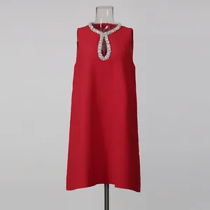 Detailed view of red shift dress featuring crystal-embellished keyhole neckline