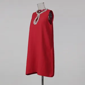 Close-up of red sleeveless dress with sparkling rhinestone keyhole neckline detail