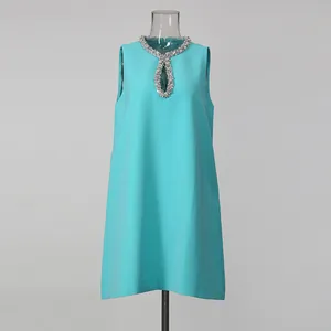Front detail view of turquoise sleeveless dress with rhinestone-embellished collar