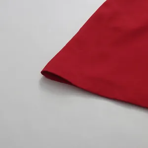 Detailed macro view of the smooth red fabric hem on this elegant sleeveless dress