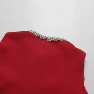 Close-up of the elegant red dress neckline with sparkling silver rhinestone embellishments