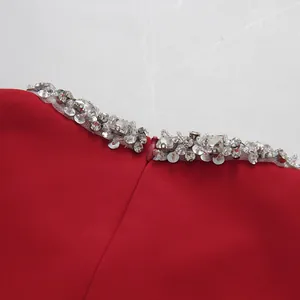 Close-up detail of silver rhinestone and bead embellishment on red dress neckline