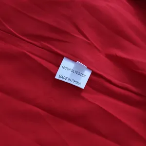 Close-up of garment care label showing 100% polyester fabric and made in China