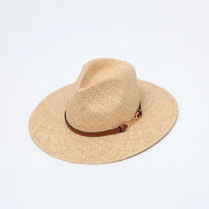 Detail view of a fine raffia straw sun hat with a decorative striped buckle band
