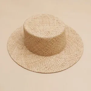 Detailed view of a vintage hand-woven raffia straw sun hat with fine texture and round top