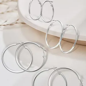 Set of silver stainless steel hoop earrings in various sizes for a minimalist look.