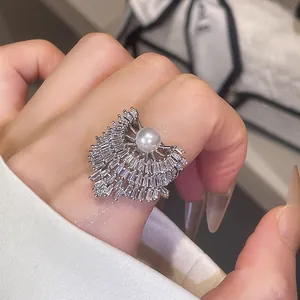 Gros plan d'une bague élégante en zircone en forme d'éventail avec perle