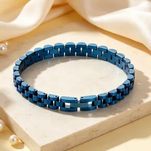 Close-up detail of a blue stainless steel bracelet featuring a watch strap link design