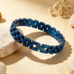 Macro view of blue metallic watch-chain style bracelet on natural stone background