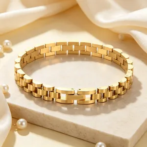 Elegant gold stainless steel watch band style bracelet presented on a luxury marble display