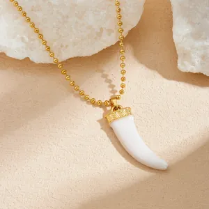 Detailed close-up of a vintage gold-plated stainless steel horn pendant necklace for women.