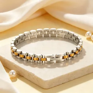 Close-up of a bicolor silver and gold stainless steel watch band style bracelet