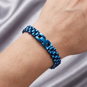 Detailed view of a stylish blue stainless steel watch-strap style link bracelet worn on wrist