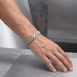 Macro view of a classic silver stainless steel watch link bracelet on a wrist for men and women