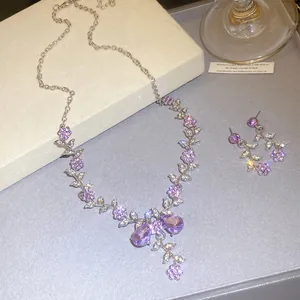 Elegant bridal jewelry set featuring purple crystal flower necklace and matching earrings