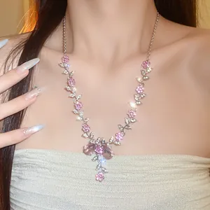 Close-up of pink flower rhinestone necklace showing delicate sparkling floral details