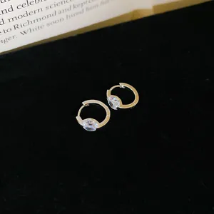 Close-up of elegant silver-tone hoop earrings with sparkling marquise-cut zircon
