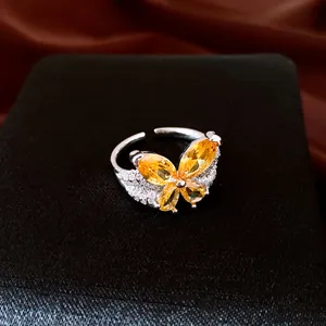 Close-up of elegant yellow zircon butterfly motif on silver-plated open ring
