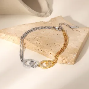 Detailansicht eines zweifarbigen Armbands mit strassbesetzten, ineinandergreifenden Ringen