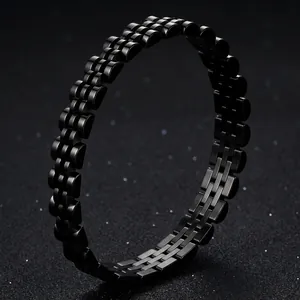 Close-up of black titanium steel watch-link style bracelet on textured background