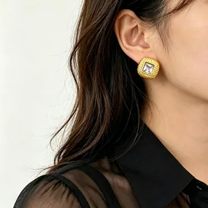 Detailed close-up view of a minimalist gold titanium steel stud earring with square zircon