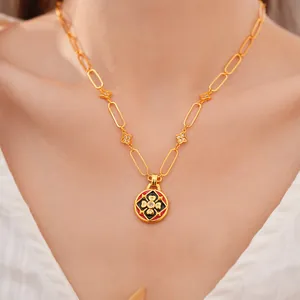 Dettaglio collana fiore placcata oro 24K con smalto rosso e zirconi su modella