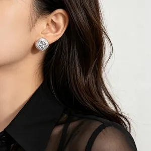 Elegant minimalist square zircon stud earring with textured silver frame on model's ear
