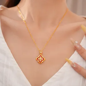 Dettaglio di una collana placcata in oro 24K con fiore in smalto rosso e inserto in zircone