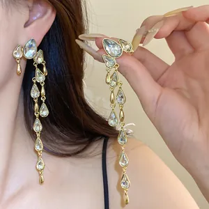 Close-up view of elegant silver needle water-drop tassel earrings with clear crystals