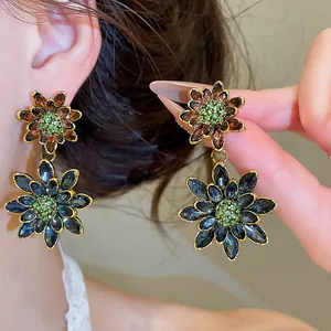 Detail view of vintage double-layer flower earrings with colorful crystals and gold trim