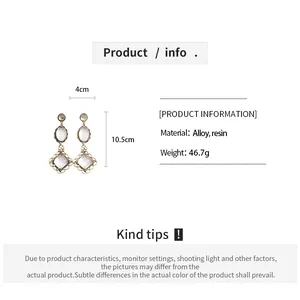 Detail view of vintage resin and alloy dangle earrings with measurements and weight.