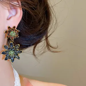 Detailed view of vintage double-layer floral earrings with navy blue and brown crystals.