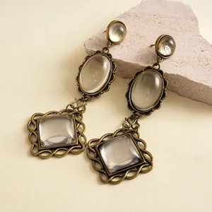 Vintage bronze metal drop earrings with resin stones and scalloped details for a retro look