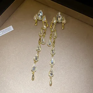 Elegant gold-plated long tassel earrings featuring multiple clear teardrop rhinestones