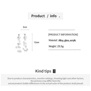 Detail view of translucent acrylic floral tassel earrings showing 12cm length and material info