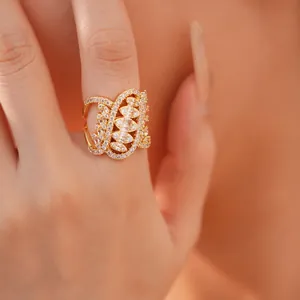 Detail shot of an intricate gold-plated ring with sparkling cubic zirconia pavé setting