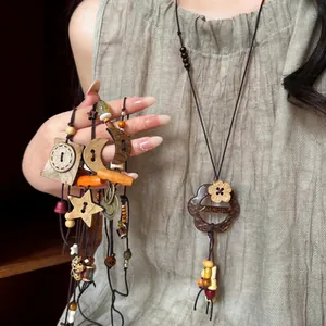 Vintage ethnic style long beaded necklace featuring wooden stars and moon charm pendants
