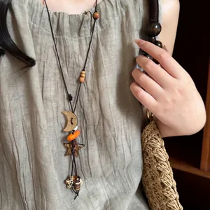 Vintage long necklace featuring star and moon charms with rustic wooden beads