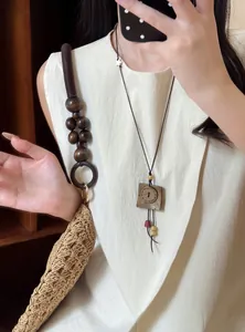 Retro New Chinese style long wooden beaded necklace with square button pendant and woven bag.