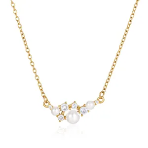 Elegant gold titanium steel necklace with white pearls and sparkling cubic zirconia.