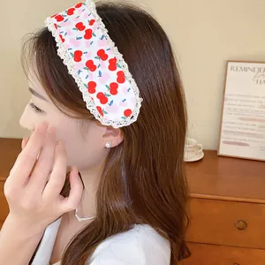 Detailed view of sweet cherry print hair magic sticker with lace trim on model hair