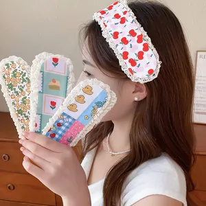 Detailed view of sweet floral and cherry print hair fringe stickers for hair styling.