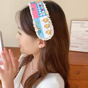 Close-up of a sweet floral knitted hair grip worn by a model in a cozy lifestyle setting