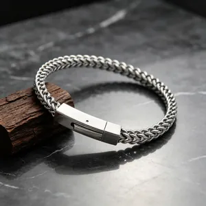 Detail shot of the polished stainless steel wheat chain bracelet with a square clasp.